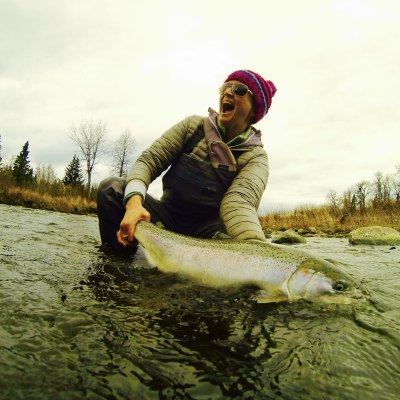 Excited fly fisher releasing a Steelhead in Alaska