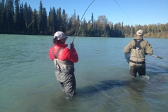 Angler hooked up and guide netting fish