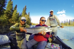 Group of 2 anglers and guide with Steelhead in jetboat