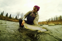 Excited fly fisher releasing a Steelhead in Alaska